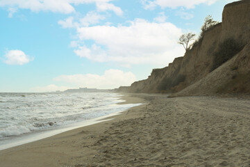 Sandy beach with clay slopes, space for text