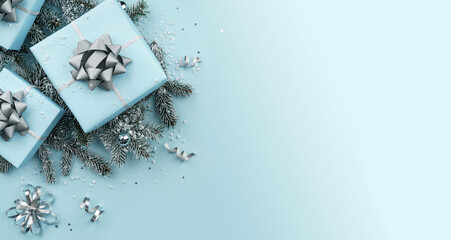 Christmas gift boxes with silver ribbons, decoration, bows, sparkles, fir branches, snowflakes and confetti on blue background. Xmas and New Year greeting card, winter holiday. Top view, banner