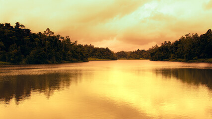 Golden sunset colors in Hiyare reservoir landscape photograph.