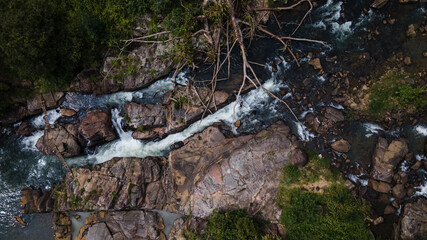 Beautiful river flows down through the rocks in the forest 