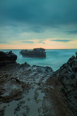 Picturesque seascape. Amazing landscape. Rock in the ocean. Motion waves. Silky water. Long exposure image. Soft focus. Concept of nature background. Mengening beach, Bali