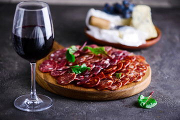 The cut salami sausage on a chopping board