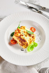 Lasagna with tomato and green leaf