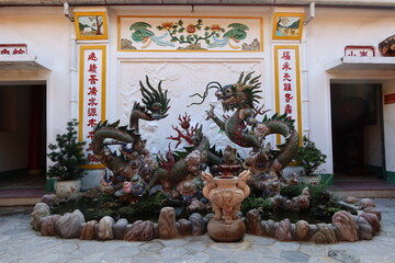 Hoi An, Vietnam, October 29, 2020: Fountain with a dragon in the backyard of the Assembly Hall Of Fujian Chinese Temple in Hoi An