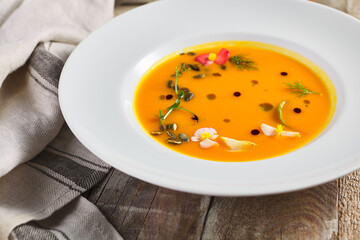 Yellow Pumpkin Soup on wooden table