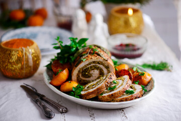 Turkey porchetta with caramelised clementines on the Christmas background .style rustic.
