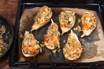 Eggplant stuffed on them, prepared for baking on a baking sheet, top view