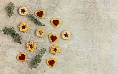 Traditional Austrian Christmas cookies - Linzer biscuits filled with red berry jam. Flatlay with copy space.