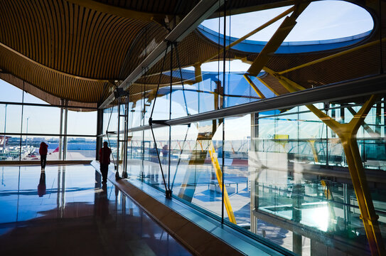 Interior view of the Madrid Barajas International Airport. Many reflections in glass windows. Modern airport glass view in international terminal T4. Madrid, Span.