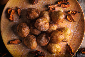 Bunuelos de viento - traditional Colombian sweet deep fried pastry. Spanish Easter doughnut. Mexican golden, crispy-sweet, tortilla-like fritters are sprinkled with sugar