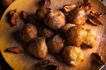 Bunuelos de viento - traditional Colombian sweet deep fried pastry. Spanish Easter doughnut. Mexican golden, crispy-sweet, tortilla-like fritters are sprinkled with sugar