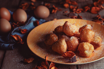 Bunuelos de viento - traditional Colombian sweet deep fried pastry. Spanish Easter doughnut. Mexican golden, crispy-sweet, tortilla-like fritters are sprinkled with sugar