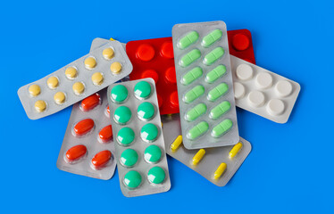 Packs of pills on blue background