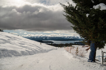 landscape with snow road to the river and the frozen mountains in the background