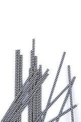 Black and white paper straws isolated on white background.