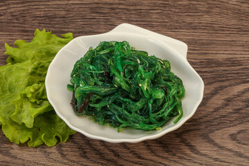 Green Chuka Seaweed Salad Isolated on White Background Top View. Wakame Sea Kelp Salat