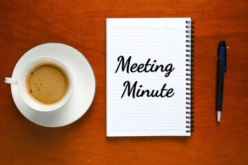 Flatlay picture of notebook written meeting minute, pen and a cup of coffee. 
