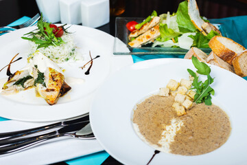 Mushroom soup, white fish fillet with herbs and rice, salad with chicken breast and vegetables.