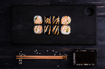 Minimalistic sushi on dark wooden background