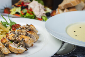 Top view of a restaurant table served with a multi-course set lunch and drink. Complex lunch.
