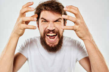 emotional man with a beard gesturing with his hands close-up studio aggression