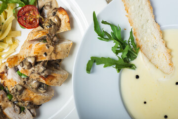Top view of a restaurant table served with a multi-course set lunch and drink. Complex lunch.