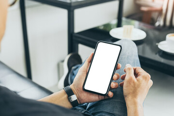 cell phone blank white screen mockup.man hand holding texting using mobile on desk at coffee shop.background empty space for advertise.work people contact marketing business,technology