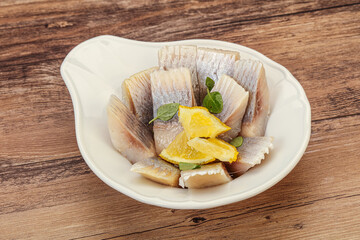 Herring fillet with sliced lemon
