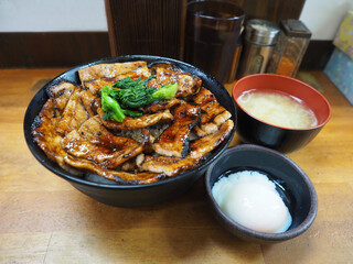  Japanese grilled barbecue pork top on rice in a bowl serve with soft-boiled eggs and soup