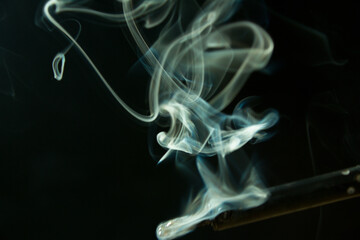 Obraz premium soldering iron with smoke from the sting of burning rosin. Photo on a black background