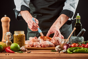 Man brushing chicken wings with barbecue sauce