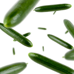 Many cucumbers free falling on white background. Selective focus - shallow depth of field.