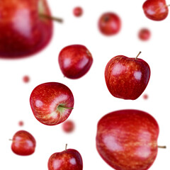 Many red apples free falling on white background. Selective focus - shallow depth of field.