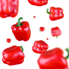 Many red bell peppers free falling on white background. Selective focus - shallow depth of field.