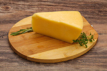 Hard cheese piece served rosemary