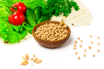 Chickpea beans in wooden bowl. fresh tomatoes, cucumbers, lettuce salad on tablecloth isolated on white background. Organic, healthy food concept