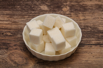 Refined white sugar cubs in the bowl