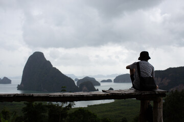 A man with a hat sitting in the view