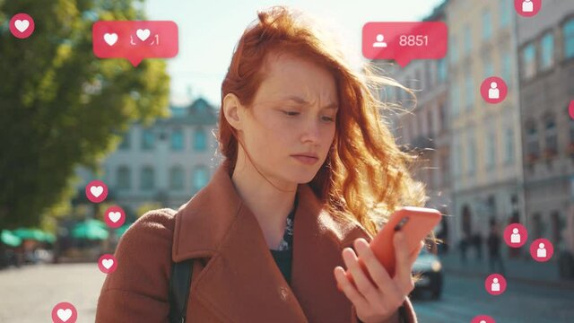 Serious ginger girl with smartphone looking at screen. Unhappy young woman noticing decrease in number of subscribers in social media. Unsuccessful marketing strategy. Negative reaction on last post