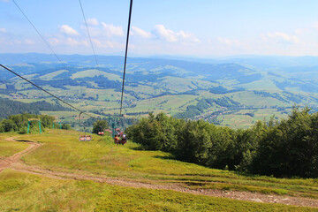 Ski lift that takes tourists and skiers to the top of the Borzhava ridge in Carpathian mountains, Transcarpathia, Western Ukraine. Amazing vacation in the Ukrainian mountains. Mountainous countryside