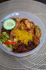 Nasi Ambeng or Nasi Ambang. It is a fragrant rice dish that consists of steamed white rice, chicken curry or chicken stewed in soy sauce, beef or chicken rendang, sambal goreng urap, bergedel.