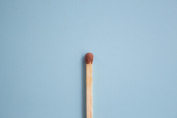  Match on a blue background close-up. Minimalism concept, pastel colors. Top view, flat lay