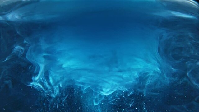 Paint fall into water which is twist. Spin acrylic ink drip into liquid. Visual effect bullet time, frozen moment, flow motion. Cloud fraction of color is spray drop. Slow motion cosmic video magic.