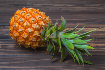 Ripe pineapple fruit, lie on a background of wooden boards