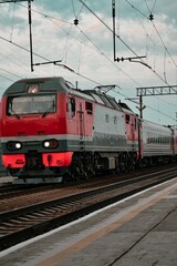 Fototapeta na wymiar Locomotive with passenger wagons, railway, rails, tracks, train red