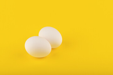 chicken eggs on yellow background