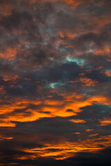 Fire red clouds shine in the air in the evening sun.