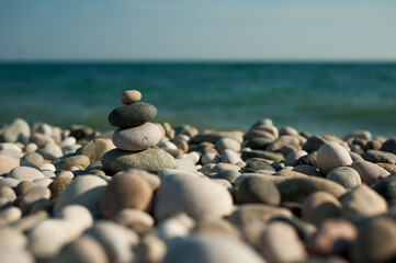 Feng Shui. Pyramid. Round stones on the beach.