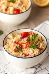 Tabouleh is an Arabic vegetarian salad made with couscous, tomatoes, parsley. Healthy lunch