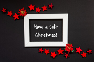 Frame With English Text Have A Safe Christmas. Christmas Decoration And Ornament Like Red Winter Rose And Stars. Black Background